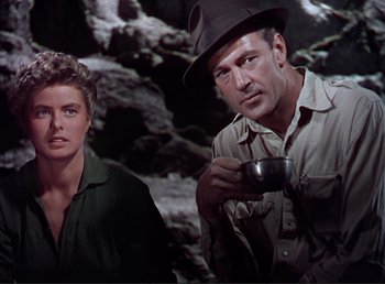 Movie still from “For Whom the Bell Tolls” (1943), directed by Sam Wood – A man and a woman are standing next to each other; Medium shot, Low angle