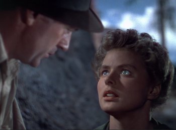 Movie still from “For Whom the Bell Tolls” (1943), directed by Sam Wood – A man and a woman are looking at one another; Close Up shot, Low angle