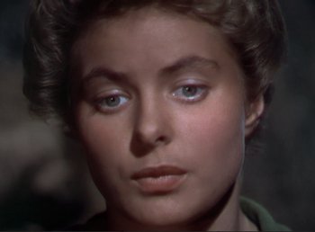 Movie still from “For Whom the Bell Tolls” (1943), directed by Sam Wood – A woman's face in a dark room; Close Up shot, High angle