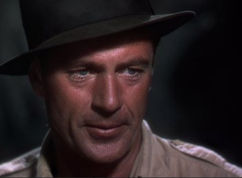 Movie still from “For Whom the Bell Tolls” (1943), directed by Sam Wood – A person wearing a hat; Close Up shot, Over the shoulder angle