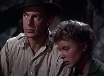 Movie still from “For Whom the Bell Tolls” (1943), directed by Sam Wood – An older man standing next to a younger woman; Close Up shot, Low angle