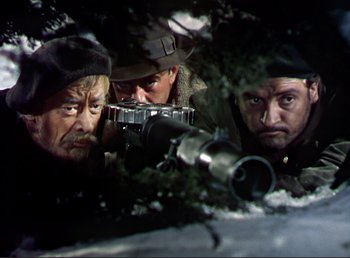Movie still from “For Whom the Bell Tolls” (1943), directed by Sam Wood – A group of men standing next to each other in the snow; Close Up shot, Low angle
