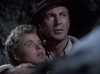 Movie still from “For Whom the Bell Tolls” (1943), directed by Sam Wood – A man and a woman are looking into the distance; Close Up shot, Low angle