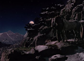 Movie still from “For Whom the Bell Tolls” (1943), directed by Sam Wood – A horse standing on top of a hill at night; Wide shot, Low angle