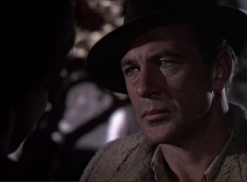 Movie still from “For Whom the Bell Tolls” (1943), directed by Sam Wood – A person wearing a hat; Close Up shot, Over the shoulder angle