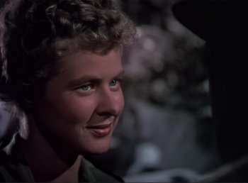 Movie still from “For Whom the Bell Tolls” (1943), directed by Sam Wood – A woman's face in the dark; Close Up shot, Over the shoulder angle