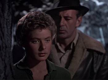 Movie still from “For Whom the Bell Tolls” (1943), directed by Sam Wood – A man and a woman standing next to each other; Close Up shot, Over the shoulder angle