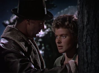 Movie still from “For Whom the Bell Tolls” (1943), directed by Sam Wood – A man and a woman are talking to each other; Close Up shot, Low angle