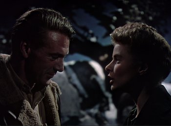 Movie still from “For Whom the Bell Tolls” (1943), directed by Sam Wood – A man and a woman face to face in a dark setting; Close Up shot, Low angle