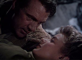 Movie still from “For Whom the Bell Tolls” (1943), directed by Sam Wood – A man and a boy are playing with a teddy bear; Close Up shot, Low angle