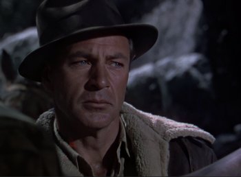 Movie still from “For Whom the Bell Tolls” (1943), directed by Sam Wood – A person wearing a hat; Close Up shot, Over the shoulder angle