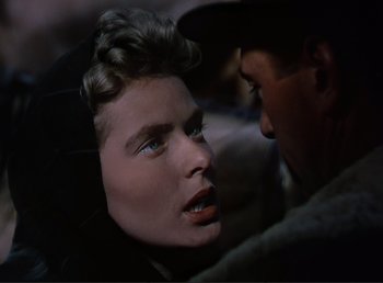 Movie still from “For Whom the Bell Tolls” (1943), directed by Sam Wood – A man and a woman face to face in the dark; Close Up shot, Over the shoulder angle