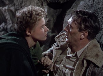 Movie still from “For Whom the Bell Tolls” (1943), directed by Sam Wood – A man and a woman in a rocky area; Close Up shot, Low angle