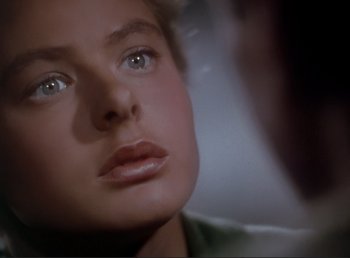 Movie still from “For Whom the Bell Tolls” (1943), directed by Sam Wood – A woman's face in front of a mirror; Close Up shot, Over the shoulder angle
