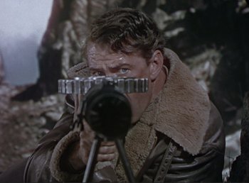Movie still from “For Whom the Bell Tolls” (1943), directed by Sam Wood – A man with a camera taking a picture of himself; Close Up shot, Over the shoulder angle