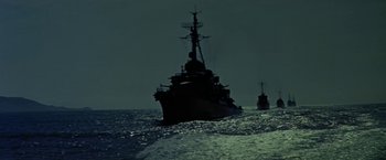 Movie still from “Force 10 from Navarone” (1978), directed by Guy Hamilton – Two ships in the ocean at night with the sky in the background; Extreme Wide shot, Low angle