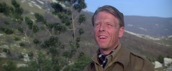 Movie still from “Force 10 from Navarone” (1978), directed by Guy Hamilton – A man smiling for the camera while wearing a hat; Close Up shot, Low angle