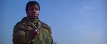 Movie still from “Force 10 from Navarone” (1978), directed by Guy Hamilton – A man holding a wrench in his hand; Close Up shot, Low angle
