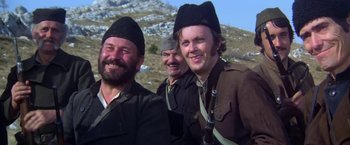 Movie still from “Force 10 from Navarone” (1978), directed by Guy Hamilton – A group of men standing on top of a hill; Close Up shot, Low angle
