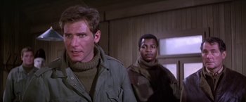 Movie still from “Force 10 from Navarone” (1978), directed by Guy Hamilton – A man and a woman standing next to each other in a room; Close Up shot, Low angle