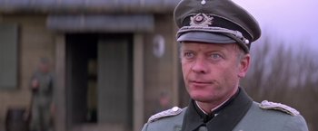Movie still from “Force 10 from Navarone” (1978), directed by Guy Hamilton – A person wearing a uniform; Close Up shot, Low angle