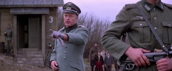 Movie still from “Force 10 from Navarone” (1978), directed by Guy Hamilton – A man in a military uniform pointing at something; Medium shot, Over the shoulder angle