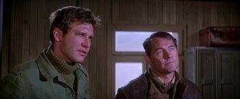 Movie still from “Force 10 from Navarone” (1978), directed by Guy Hamilton – A couple of men standing next to each other in front of a window; Close Up shot, Low angle