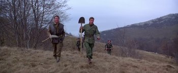 Movie still from “Force 10 from Navarone” (1978), directed by Guy Hamilton – A group of men walking across a field; Wide shot, Low angle