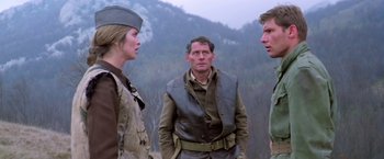 Movie still from “Force 10 from Navarone” (1978), directed by Guy Hamilton – A group of people standing next to each other in a field; Medium shot, Over the shoulder angle