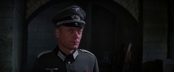 Movie still from “Force 10 from Navarone” (1978), directed by Guy Hamilton – A person wearing a military uniform; Close Up shot, Low angle