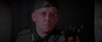Movie still from “Force 10 from Navarone” (1978), directed by Guy Hamilton – An older man wearing glasses and wearing a hat; Close Up shot, Low angle
