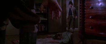 Movie still from “Force 10 from Navarone” (1978), directed by Guy Hamilton – Two people are lying on the floor in a living room; Wide shot, High angle