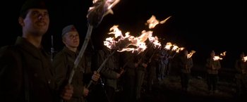 Movie still from “Force 10 from Navarone” (1978), directed by Guy Hamilton – A group of men holding torches in the dark; Medium shot, Low angle
