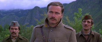 Movie still from “Force 10 from Navarone” (1978), directed by Guy Hamilton – A person wearing a coat and a mustache; Close Up shot, Low angle