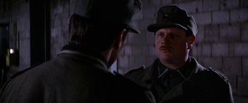 Movie still from “Force 10 from Navarone” (1978), directed by Guy Hamilton – A man in a military uniform looking at himself in the mirror; Close Up shot, Over the shoulder angle