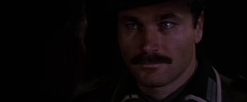 Movie still from “Force 10 from Navarone” (1978), directed by Guy Hamilton – A person with a mustache; Close Up shot, Over the shoulder angle