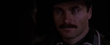 Movie still from “Force 10 from Navarone” (1978), directed by Guy Hamilton – A person with a mustache; Close Up shot, Over the shoulder angle