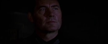 Movie still from “Force 10 from Navarone” (1978), directed by Guy Hamilton – A person wearing a black shirt; Close Up shot, Low angle