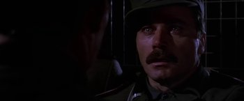 Movie still from “Force 10 from Navarone” (1978), directed by Guy Hamilton – A person wearing a hat; Close Up shot, Over the shoulder angle