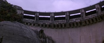 Movie still from “Force 10 from Navarone” (1978), directed by Guy Hamilton – A view of a large concrete structure with a sky in the background; Extreme Wide shot, Low angle