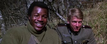 Movie still from “Force 10 from Navarone” (1978), directed by Guy Hamilton – Two men in military uniforms smiling for the camera; Close Up shot, Low angle