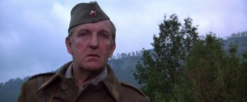 Movie still from “Force 10 from Navarone” (1978), directed by Guy Hamilton – A person wearing a military uniform; Close Up shot, Low angle