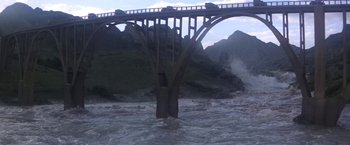 Movie still from “Force 10 from Navarone” (1978), directed by Guy Hamilton – A bridge over a body of water near a body of water; Extreme Wide shot, High angle