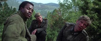Movie still from “Force 10 from Navarone” (1978), directed by Guy Hamilton – A group of people standing on top of a hill; Medium shot, Low angle