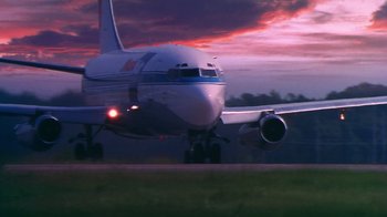 Movie still from “Forces of Nature” (1999), directed by Bronwen Hughes – An airplane taking off from a runway at sunset; Extreme Wide shot, Low angle