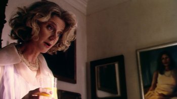 Movie still from “Forces of Nature” (1999), directed by Bronwen Hughes – A woman holding a glass of orange juice in a room; Close Up shot, Low angle
