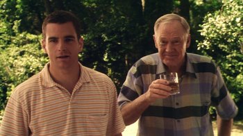 Movie still from “Forces of Nature” (1999), directed by Bronwen Hughes – Two men standing next to each other holding a glass; Medium shot, Over the shoulder angle