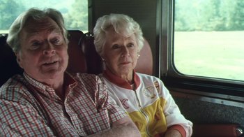 Movie still from “Forces of Nature” (1999), directed by Bronwen Hughes – Two older women sitting on a train looking out the window; Medium shot, High angle