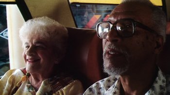 Movie still from “Forces of Nature” (1999), directed by Bronwen Hughes – An older man and woman sitting next to each other; Close Up shot, High angle