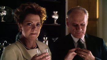 Movie still from “Forces of Nature” (1999), directed by Bronwen Hughes – An older man and a younger woman holding glasses; Close Up shot, Low angle